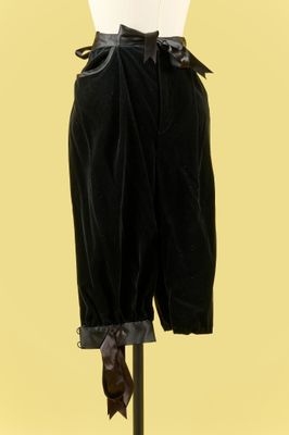 une photo d'un mannequin portant une chemise blanche et un pantalon noir