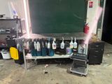 a picture of a workbench in a garage with a chalkboard in the background