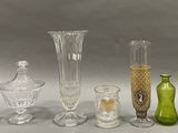 a lot of glass vases that are sitting on a table