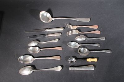 a lot of spoons and spoon knives on the table