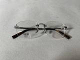 glasses on a white surface with a pair of glasses on top of it