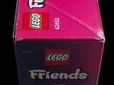 a box of lego friends cat toys on a black background