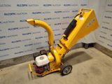 a close up of a small machine on wheels in a room