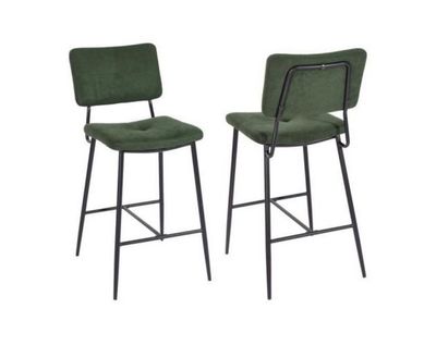 a pair of green velvet bar stools with metal legs