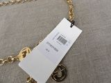 a close up of a gold chain with a tag attached to it