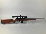 a rifle with a scope mounted on the side of it