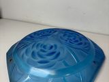 a blue plastic object sitting on a white counter