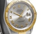 a close up of a watch with roman numerals on the dial