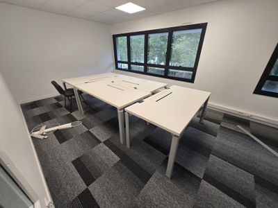 a room with two tables and two chairs in it