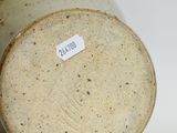 a close up of a vase with a label on it