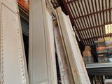 many pieces of furniture that are stacked up in a warehouse