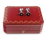 pair of cufflinks in red leather box with gold trimming