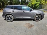 a grey suv parked on the side of the road