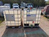 two containers that are sitting next to each other on the ground