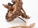 a wooden toy that is sitting next to some wooden spoons
