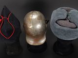 three hats are lined up on top of each other on a black surface