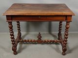an old wooden table with a drawer on top of it