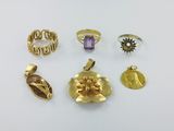 un ensemble de bagues et de pendentifs en or sur un fond blanc