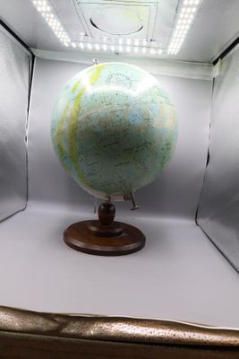 a small globe in a box with lights on it