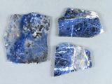 trois morceaux de marbre bleu et blanc posés sur une surface blanche