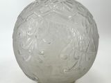 a glass vase with a design on it on a white surface
