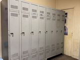 a room with a bunch of lockers and a chair in it