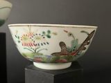pair of chinese porcelain bowls on stands on a black surface