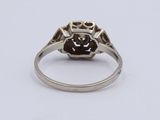 a close up of a ring with a brown stone in it