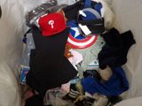 a pile of clothing and other items in a trash can