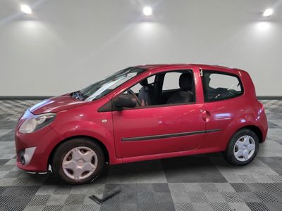 a small red car that is parked on a checkered floor