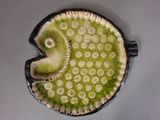 a picture of a ceramic ornament with a green and white design