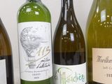 several bottles of wine are lined up on a table