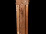 an image of a wooden column with a carved top on a black background