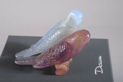 three glass birds sitting on top of a black box