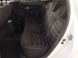 the interior of a white car with black leather seats and a black steering wheel