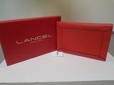 a pair of red leather wallets sitting on top of a white table