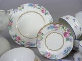 many different types of porcelain dishes and cups on the table