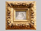 an old picture of a woman and child in a gold frame