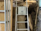 a man that is standing next to a ladder