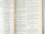 an open book on a table with a bunch of pages on it