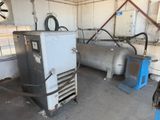 two air compressors in the garage of a building