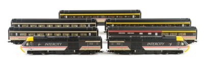 three black and yellow train cars sitting next to each other on a white surface