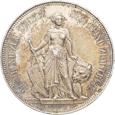 a close up of a silver coin with a statue on it