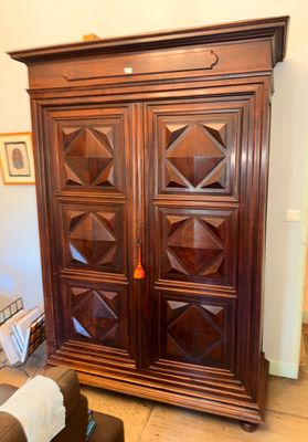 an image of a large wooden armoire in a living room