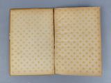 an open book with gold stars on a blue background