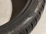 a close up of a tire on a white surface with a black rim