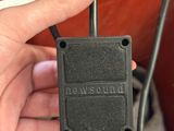 a person holding a plug in their hand and plugged into the ground
