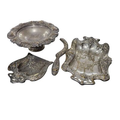 two pieces of silverware sitting on top of a white surface