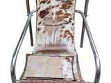 an image of a brown and white chair with a cow print seat