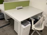 a desk with a chair and a computer on it